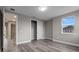 Spacious bedroom featuring wood-look floors, base molding, closet, and natural light at 1700 Underwood Ave, St Cloud, FL 34771