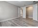 Simple bedroom with wood floors, view into open closet, and neutral colors at 1700 Underwood Ave, St Cloud, FL 34771