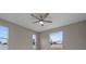 Bright bedroom featuring neutral walls, ceiling fan, and windows that allow natural light at 1700 Underwood Ave, St Cloud, FL 34771