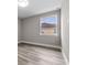 Minimalist bedroom showcasing a window with neighborhood views and neutral walls at 1700 Underwood Ave, St Cloud, FL 34771
