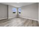 Light-filled bedroom with light gray walls, base-molding, and beautiful wood-look floors at 1700 Underwood Ave, St Cloud, FL 34771