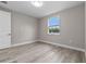Bedroom featuring modern wood floors and a window with outdoor views at 1700 Underwood Ave, St Cloud, FL 34771