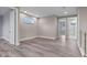 Bonus room showcasing wood-look floors, natural light, and access to other rooms and a bathroom at 1700 Underwood Ave, St Cloud, FL 34771