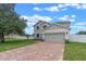 Inviting two-story home with a brick-paved driveway and well-maintained green lawn at 1700 Underwood Ave, St Cloud, FL 34771