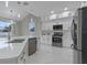 Modern kitchen features white cabinets, stainless steel appliances, pendant lights, and a large island at 1700 Underwood Ave, St Cloud, FL 34771