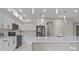 Well-designed kitchen with white cabinets, quartz countertops, stainless steel appliances and oversized island at 1700 Underwood Ave, St Cloud, FL 34771