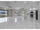 Bright, open-concept living space with large windows, marble floors, and a modern kitchen at 1700 Underwood Ave, St Cloud, FL 34771