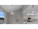 Open floor plan with modern lighting and a view of the kitchen with white cabinets at 1700 Underwood Ave, St Cloud, FL 34771