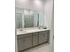 Double vanity bathroom with large mirror at 1904 Tohoqua Blvd, Kissimmee, FL 34744