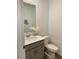 Small bathroom with gray vanity and white toilet at 1904 Tohoqua Blvd, Kissimmee, FL 34744