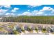 Aerial view of houses with solar panels and a tree line in the background at 1991 Hemingway Cir, Groveland, FL 34736