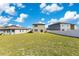 Large backyard with grassy lawn and white vinyl fence at 1991 Hemingway Cir, Groveland, FL 34736