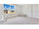 Bright bedroom with large window, carpet, and neutral walls at 1991 Hemingway Cir, Groveland, FL 34736