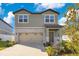 Two-story house with stone accents and a two-car garage at 1991 Hemingway Cir, Groveland, FL 34736