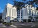 Exterior view of The Grande building, showing parking and landscaping at 202 E South St # 1050, Orlando, FL 32801