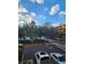 Parking lot with cars and lush green trees in the background at 202 E South St # 1050, Orlando, FL 32801