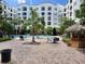 Inviting pool area features pavers, a tiki bar, lounge chairs, tables and lush greenery at 202 E South St # 1050, Orlando, FL 32801