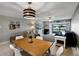 Bright dining area with wood table and white chairs, offering a casual and comfortable space at 2100 N Peninsula Ave # 1030, New Smyrna Beach, FL 32169