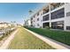 Condo building exterior showcasing waterfront pathway and lush grass at 2100 N Peninsula Ave # 1030, New Smyrna Beach, FL 32169