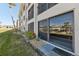 View of condo building exterior with sliding glass doors and landscaping at 2100 N Peninsula Ave # 1030, New Smyrna Beach, FL 32169