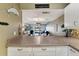 Kitchen with breakfast bar overlooking living room and water views at 2100 N Peninsula Ave # 1030, New Smyrna Beach, FL 32169