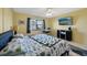 King-size bed, TV, and a workspace are in the main bedroom at 2100 N Peninsula Ave # 1030, New Smyrna Beach, FL 32169