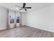 Bright bedroom featuring wood-look floors and large windows at 213 Lake Lucerne Way, Winter Haven, FL 33881