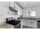 Modern kitchen featuring stainless steel appliances and white cabinetry at 213 Lake Lucerne Way, Winter Haven, FL 33881