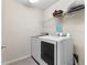 Laundry room with washer, dryer, and shelving at 213 Lake Lucerne Way, Winter Haven, FL 33881