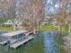 Aerial view of house with boat dock in the lake surrounded by mossy trees at 2250 W County Road 44, Eustis, FL 32726