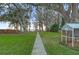 Expansive backyard featuring a walkway leading to the lake and mature trees at 2250 W County Road 44, Eustis, FL 32726