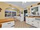 Bright kitchen featuring white cabinets, tile floors, farmhouse sink, breakfast nook, and plenty of natural light at 2250 W County Road 44, Eustis, FL 32726