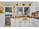 Charming kitchen with white cabinetry, farmhouse sink, and a view of the water at 2250 W County Road 44, Eustis, FL 32726