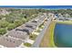 Aerial view of homes with solar panels and a lake at 2300 Grasmere View S Pkwy, Kissimmee, FL 34746