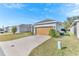 A beige house with a tan garage door and a neatly landscaped front yard at 2300 Grasmere View S Pkwy, Kissimmee, FL 34746