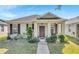 One-story house with a brown roof, purple shutters, and a landscaped lawn at 2300 Grasmere View S Pkwy, Kissimmee, FL 34746