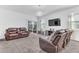 Living room with leather sofas, TV and sliding door at 2300 Grasmere View S Pkwy, Kissimmee, FL 34746