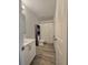 Bathroom with white vanity, shower/tub, and wood-look tile floor at 233 Gladiola Ct, Poinciana, FL 34759