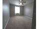 Spacious bedroom with ceiling fan and neutral carpeting at 233 Gladiola Ct, Poinciana, FL 34759