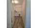 Laundry room with wood-look tile floor, cabinets, and shelving at 233 Gladiola Ct, Poinciana, FL 34759