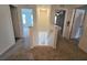 Upstairs hallway with carpet flooring and access to bedrooms at 233 Gladiola Ct, Poinciana, FL 34759