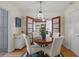 Bright dining room with a round wooden table and four chairs, hardwood floors at 2501 Center Ave, Orlando, FL 32806