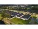 Aerial view of new homes backed by fenced yards and green space at nighttime at 2523 Avalon Park Blvd, Tavares, FL 32778