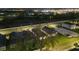 Night aerial view of townhomes with modern architecture, landscaping, and street lighting at 2523 Avalon Park Blvd, Tavares, FL 32778