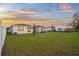 Backyard view showing large grass area with white fence surrounding the perimeter of the homes at 2523 Avalon Park Blvd, Tavares, FL 32778