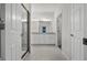 Well-lit bathroom featuring double vanity, tiled floors, and glass shower provides a functional layout at 2523 Avalon Park Blvd, Tavares, FL 32778