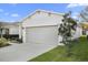 Attractive home exterior featuring a lush lawn and a two-car garage at 2523 Avalon Park Blvd, Tavares, FL 32778