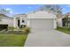 Charming one-story home with a well-manicured lawn and a two-car garage at 2523 Avalon Park Blvd, Tavares, FL 32778