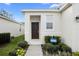 Close-up of the front door with elegant landscaping at 2523 Avalon Park Blvd, Tavares, FL 32778