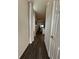 Long hallway with dark hardwood floors at 2523 Avalon Park Blvd, Tavares, FL 32778